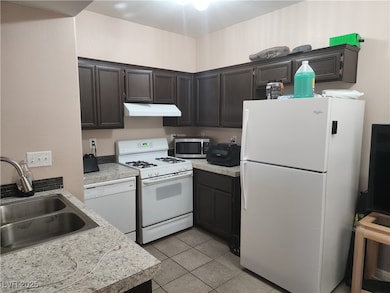 Kitchen with white appliances, under cabinet range