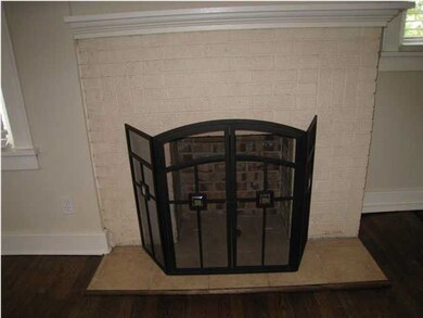 Brick fireplace with tile landing and decorative s