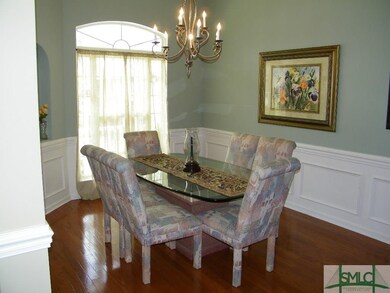 Formal dining area with tray ceiling, hardwood flo
