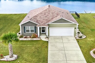 View of front facade with a water view, a front ya