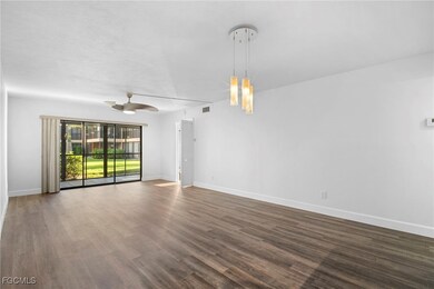 Spare room with dark wood-type flooring and ceiling fan