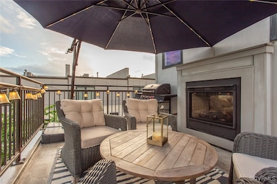 View of patio featuring a glass covered fireplace