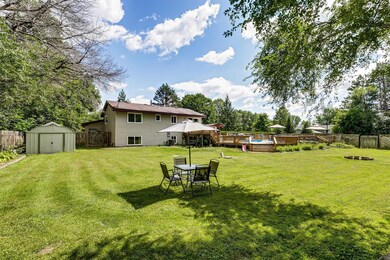 Large fully fenced backyard with heated pool, multi tiered deck, 14'x10' storage shed, and fire pit.