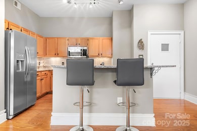 Kitchen with under cabinet lights and granite counters