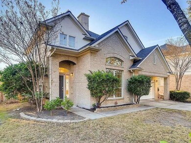 View of front of property with brick siding and a