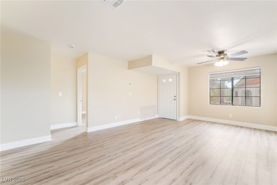 Unfurnished living room with light wood finished floors and a ceiling fan