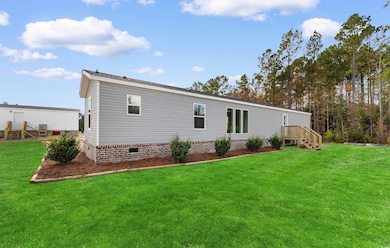Back of house with a yard and crawl space