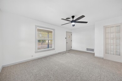 Spare room featuring carpet and a ceiling fan
