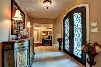 Canterra style wrought iron double doors make the foyer even more spectacular.