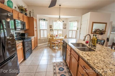 Kitchen and dining area, granite counter tops and refrigerator stays
