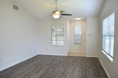 Vinyl Plank flooring, tile entry and coat closet. Cathedral ceiling with fan/light and lots of light.