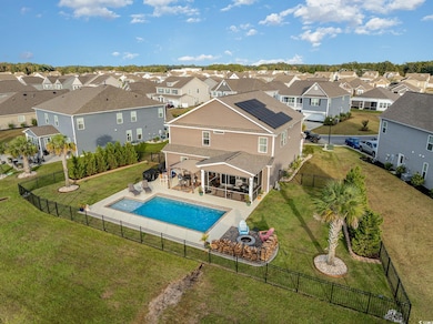 View of swimming pool with a patio and a lawn
