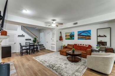 Living room featuring stairs, ceiling fan, light 