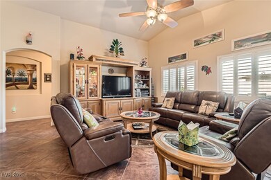 Living room with vaulted ceiling, baseboards, and