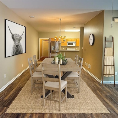 Dining area - open concept easily accomodates dining table with 6 place setting - virtually staged