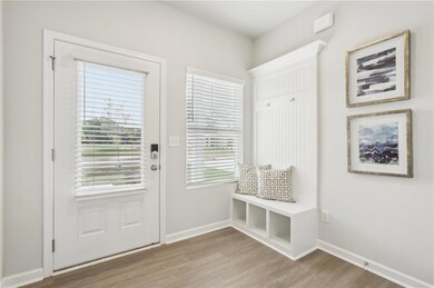 Mudroom with baseboards and light wood-style floor