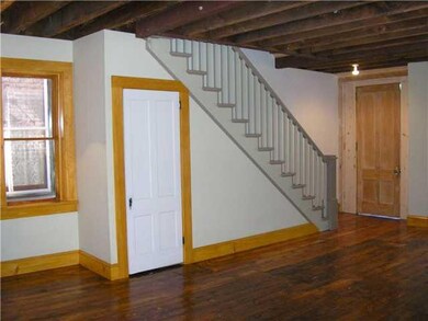 Living Room. Staircase rebuilt with original tread