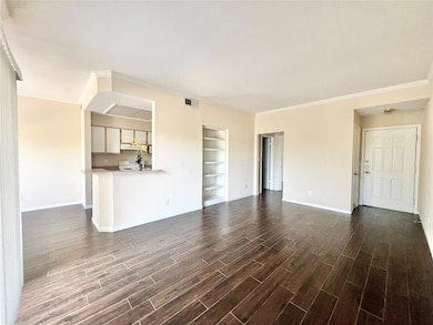 Unfurnished living room with dark wood-style floo