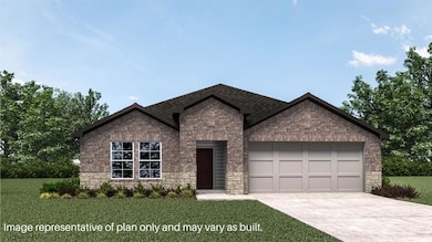 View of front of house featuring stone siding, an attached garage, brick siding, and driveway