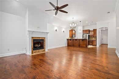 Unfurnished living room with a ceiling fan, a tile