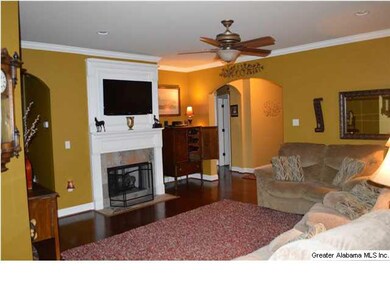 Living room with ceiling fan, fireplace and wood f
