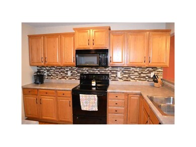 Kitchen. Hardwood floors, cabinets with crown mold