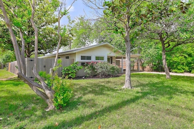 Ranch-style house with a front lawn and fence