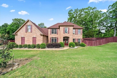 Colonial inspired home featuring brick siding