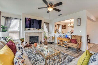 Living room featuring ceiling fan with notable cha