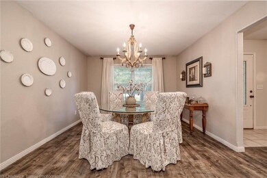 Formal dining room open to the living room/entry.  Look at this beautiful custom chandelier.