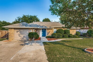 Ranch-style house with a front yard and a garage