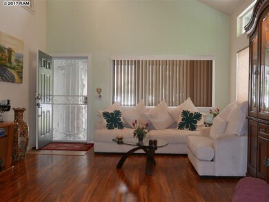 Front door opens to living room with soaring ceili