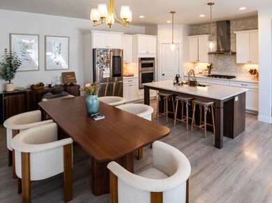 Dining area featuring a chandelier, light wood-type flooring, a textured ceiling, and recessed lighting
