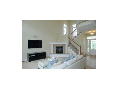 Corner fireplace with tiled surround and tiled hea