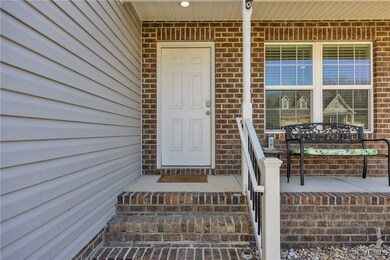 View of exterior entry with covered porch