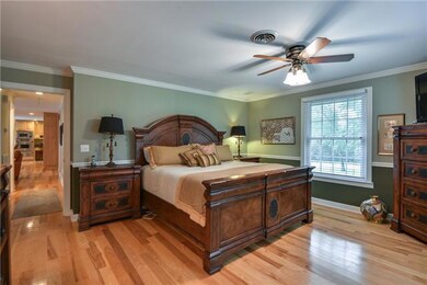 Located on the main floor, the master bedroom features hickory flooring, chair rail, ceiling fan and crown molding.  With it's own bathroom and large walk-in closet, this is the perfect owner's retreat.