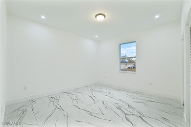 Spare room with baseboards and recessed lighting