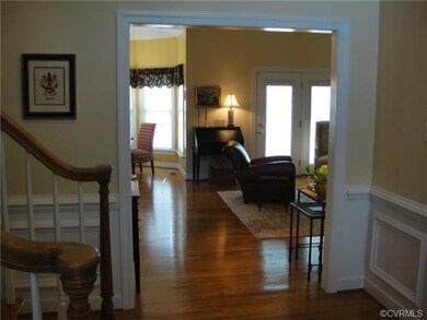 Foyer with side staircase looking into Family Room