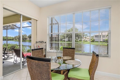 Tiled dining area with a water view and baseboards