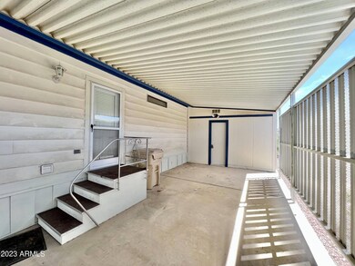 Storage shed at back of carport