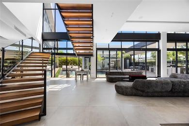 Bathed in natural light, the home is wrapped in floor-to-ceiling glass doors and windows that blur the lines between indoor comfort and outdoor beauty, highlighting a design rooted in openness and harmony. A rare opportunity, this residence is ideal for those who value exceptional architecture, ultimate privacy, and elevated living—crafted for discerning tastes and high-profile lifestyles.