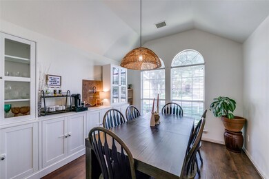 Dining area with dark wood-type flooring and lofte