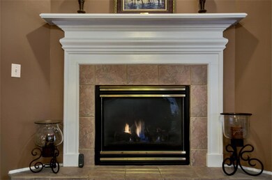 Tile surround and gorgeous mantle set off this beautiful corner fireplace