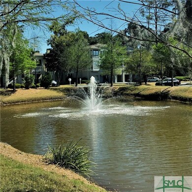 Pond with fountain just inside security gate, whic