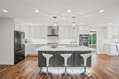 Gorgeous white kitchen with SS appliances.