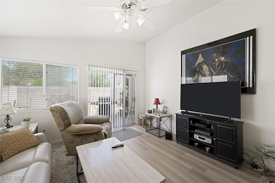 Living area featuring vaulted ceiling, wood finish