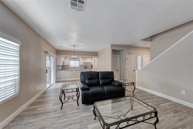 Living area with baseboards and light wood-style f