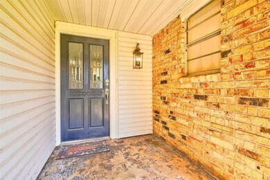 Doorway to property featuring covered porch