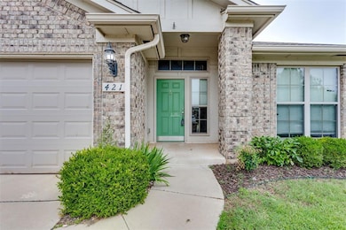 View of exterior entry featuring an attached garage and stone siding