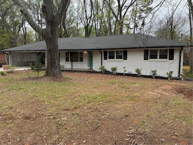 Ranch-style house with brick siding and roof with 